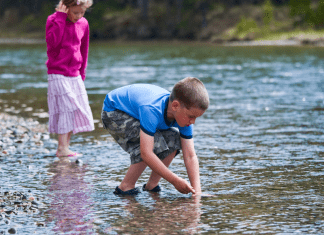 Kids play in a creek.