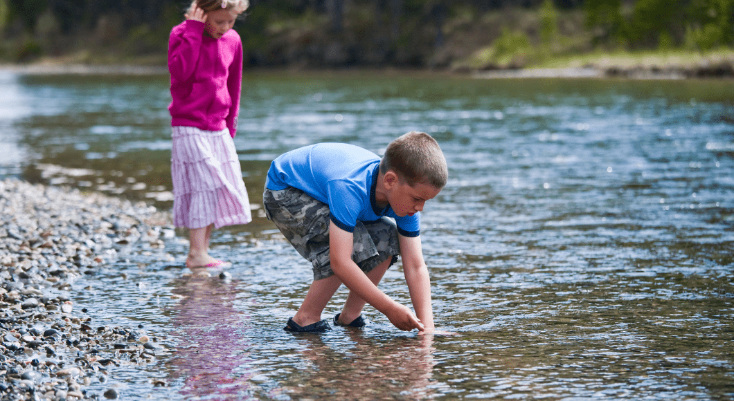 Kids play in a creek.