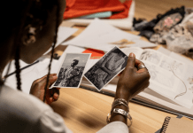 Woman looks at black and white photos of relatives.