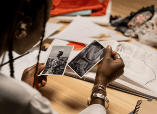 Woman looks at black and white photos of relatives.