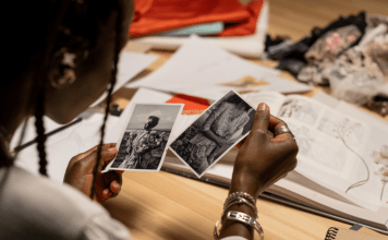 Woman looks at black and white photos of relatives.