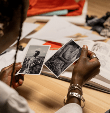 Woman looks at black and white photos of relatives.