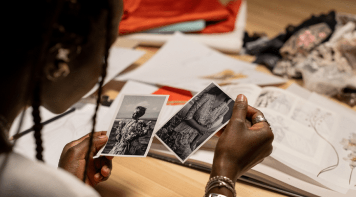 Woman looks at black and white photos of relatives.