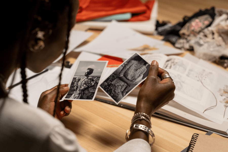 Woman looks at black and white photos of relatives.