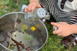 child making "soup" outside