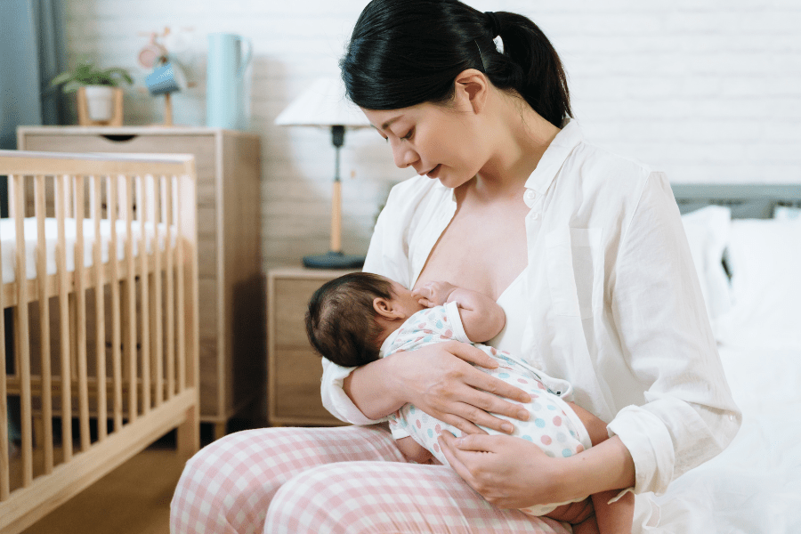 Mother wears a button-down shirt to breastfeed.