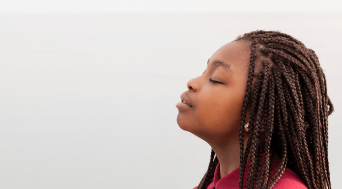 Black child breathes in deeply