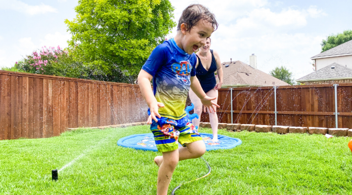 child running in sprinklers during summer when it's too hot outside