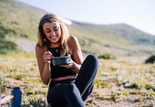 Teenage girl eats a meal outside.