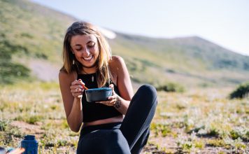 Teenage girl eats a meal outside.