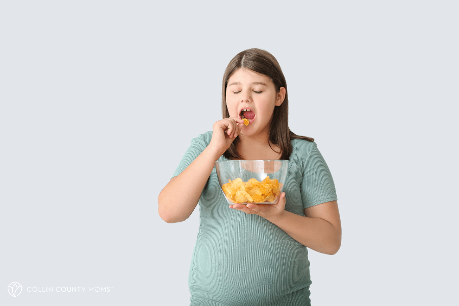 Tween girl eats chips from a bowl.