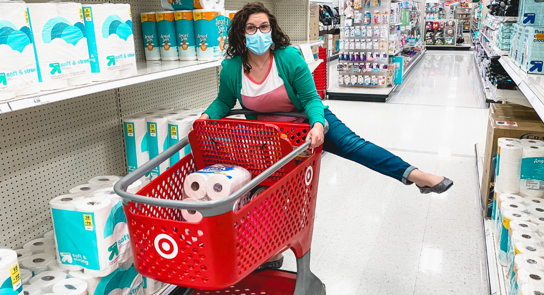 mom holding toilet paper shopping at target during covid