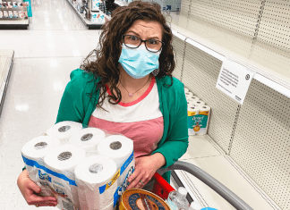 mom holding toilet paper shopping at target during covid