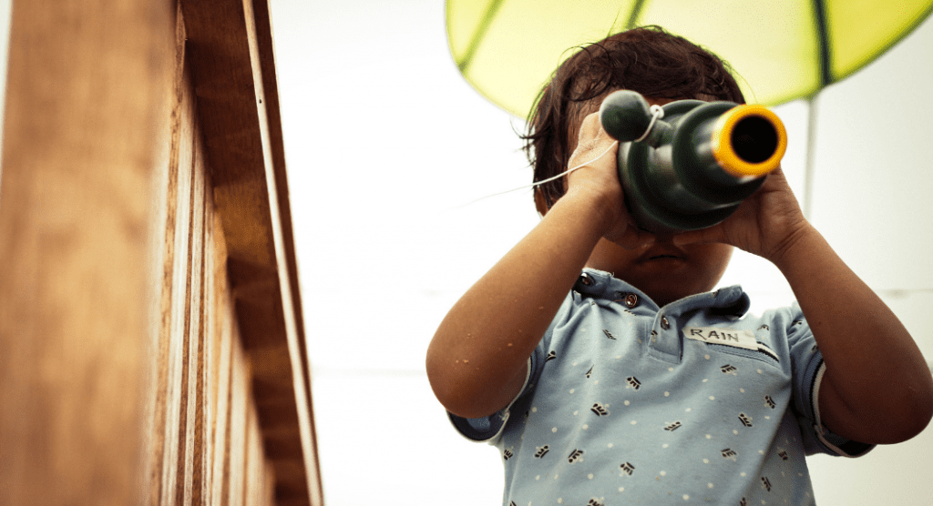 toddler looking through telescope