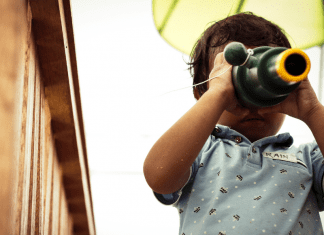 toddler looking through telescope