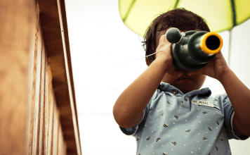 toddler looking through telescope