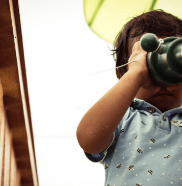 toddler looking through telescope