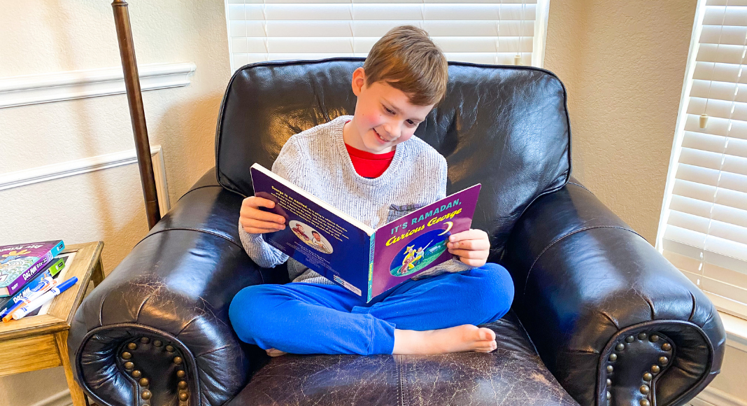 boy reading children's book about Ramadan