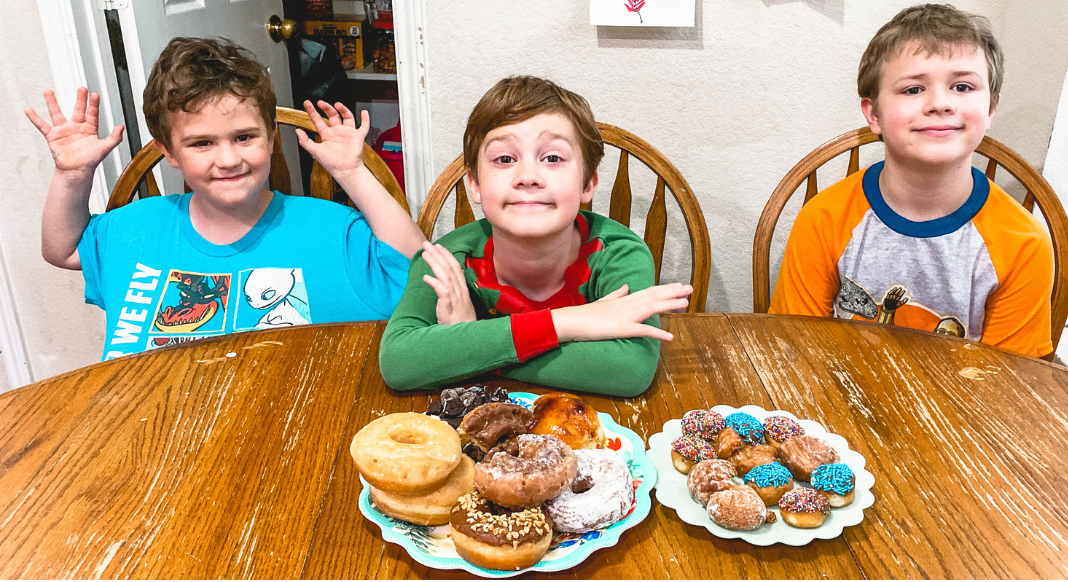 Boys sitting at a table with donuts in Allen, Texas