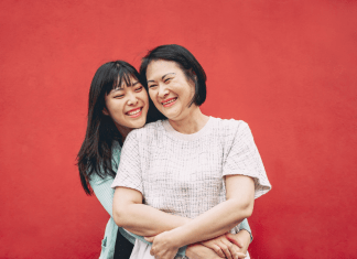 Mom and tween daughter embrace and smile