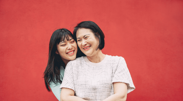 Mom and tween daughter embrace and smile