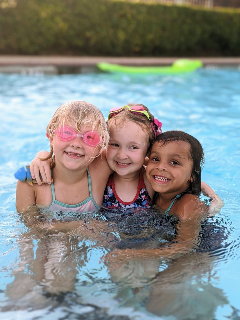 3 little girls smiling in pool, summer photo prompts