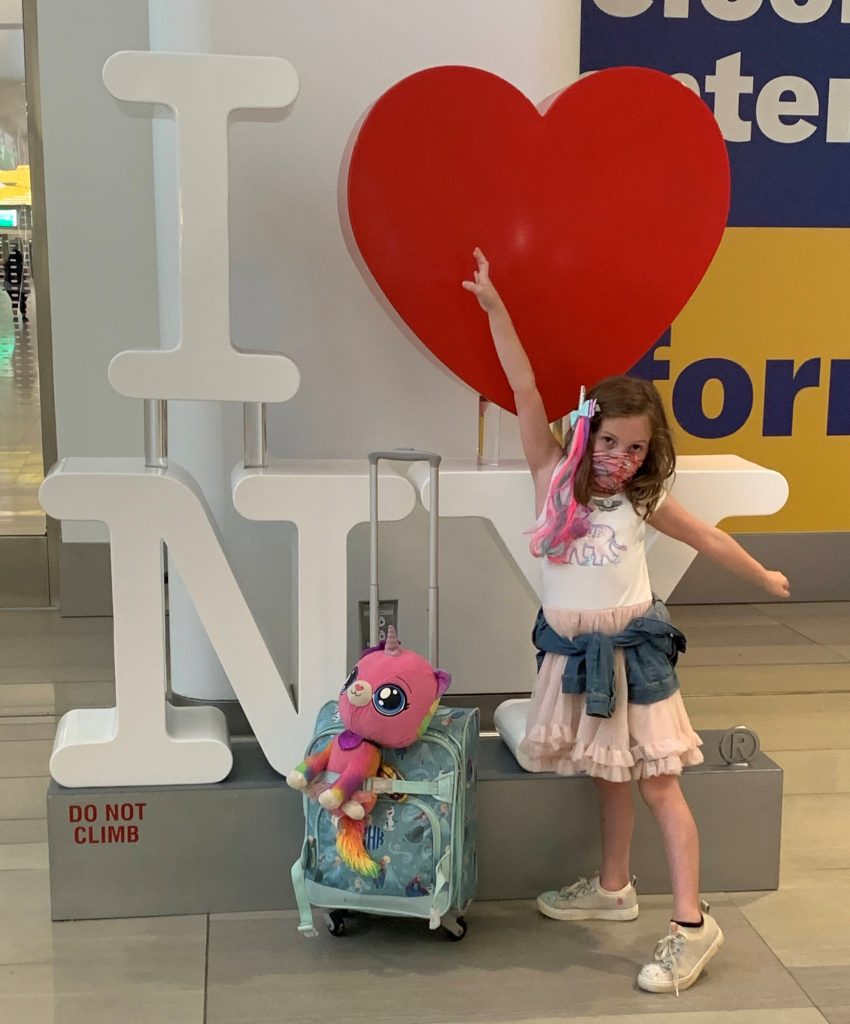 Posing in front of an I love New York sign at LaGuardia