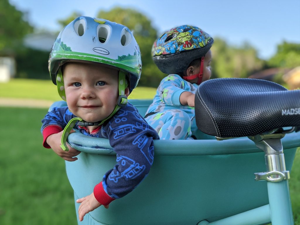 toddlers in helmets on back of bicycle, summer photo prompts
