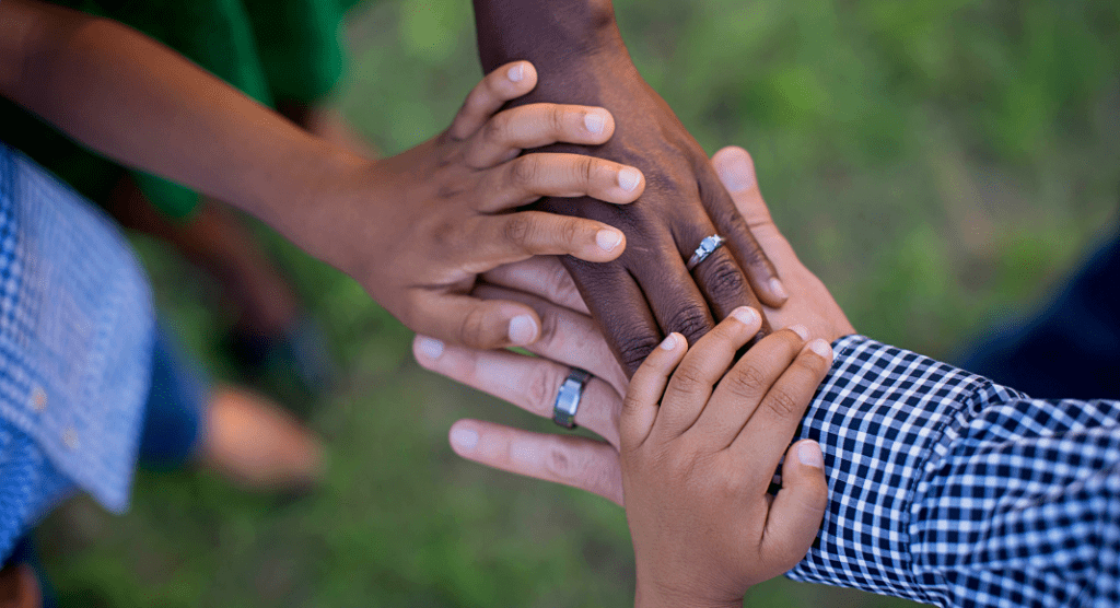 Cross cultural family holding hands