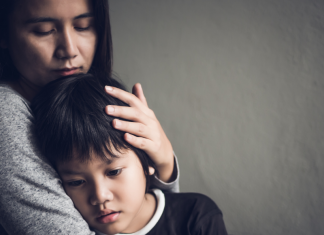 mother hugging sad child