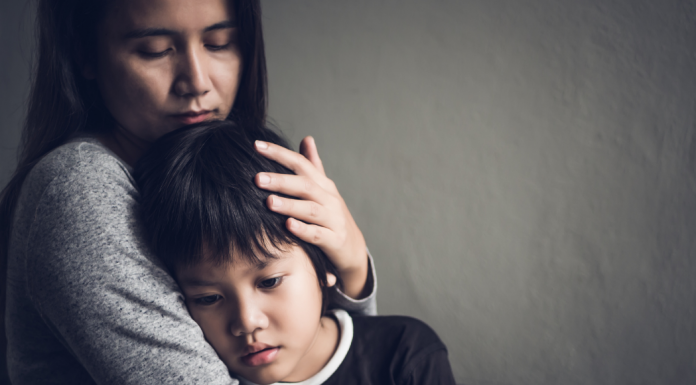 mother hugging sad child