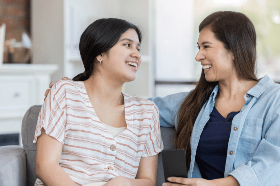 Woman and daughter laugh together.