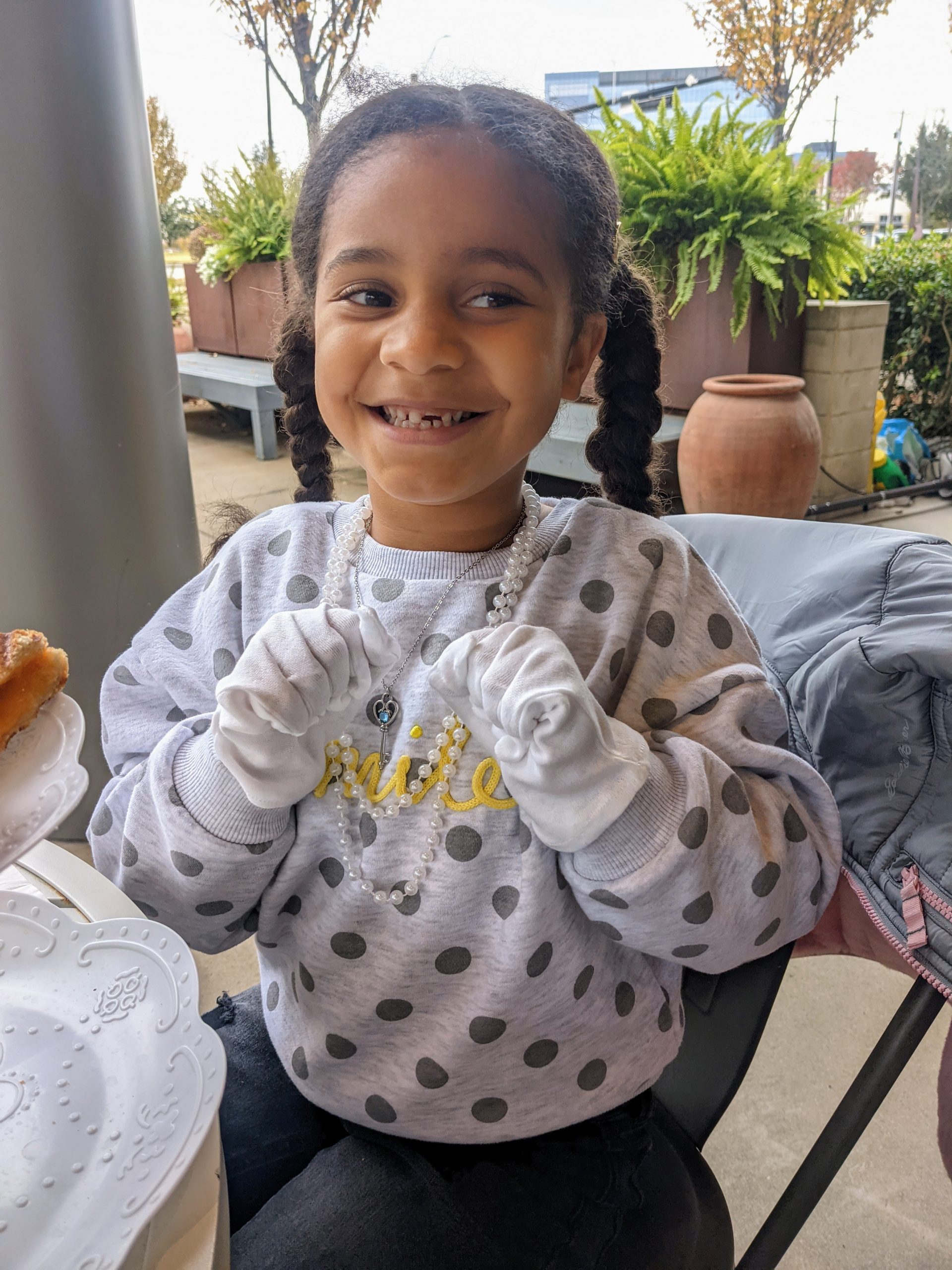 little girl in gloves and pearls at afternoon tea at Heirloom Haul in Frisco