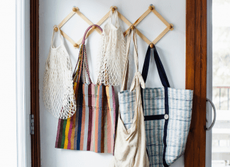 Collin County Moms: lazy mom's guide to sustainability. Picture of reusable bags hanging on hooks.