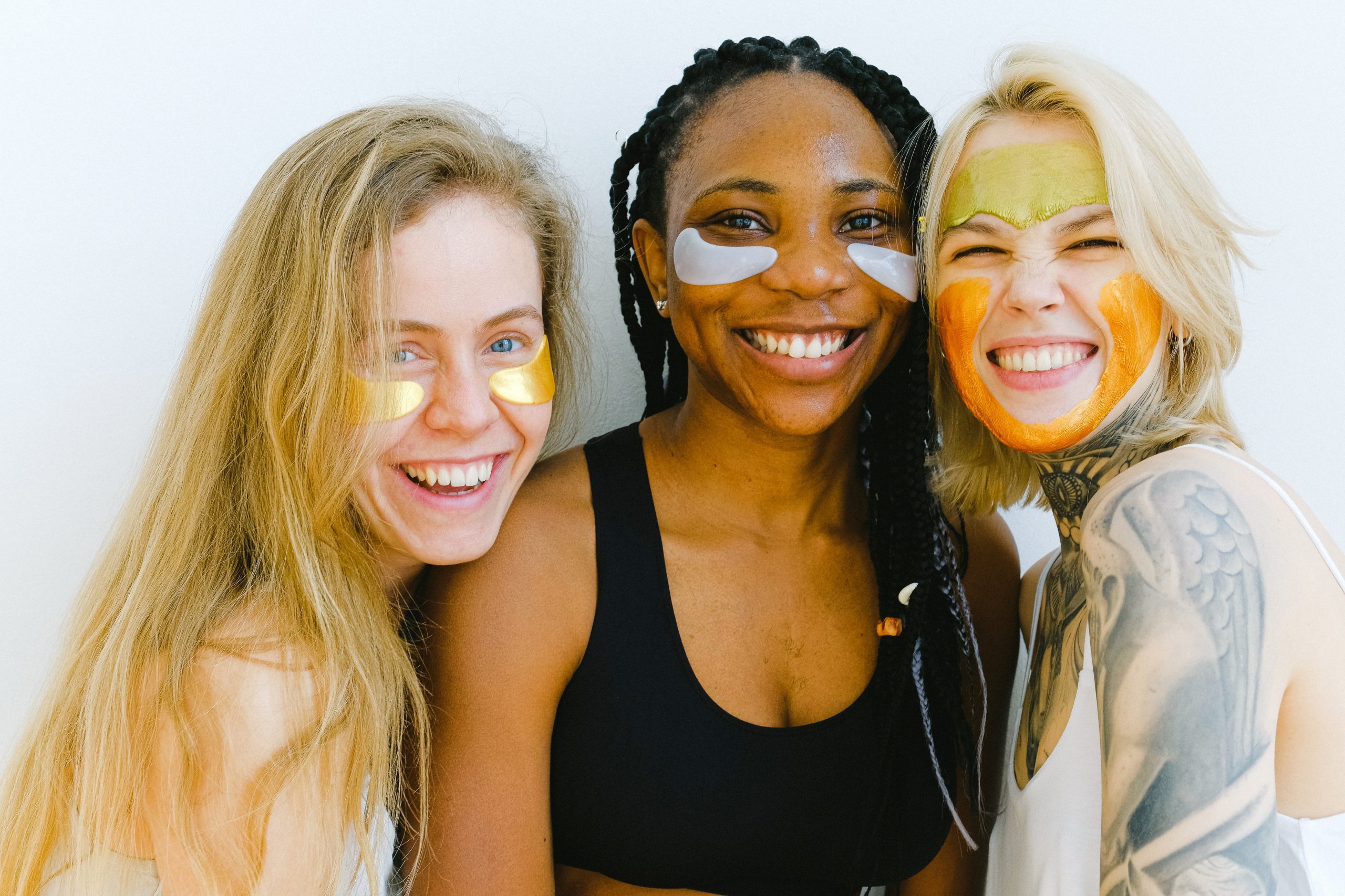 3 women smiling while doing eye masks, how to beat the winter blues