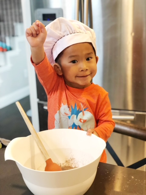 happy young boy baking at home, kid date ideas in dallas