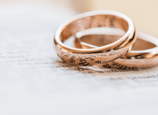 two gold wedding rings, hyphenating your married name