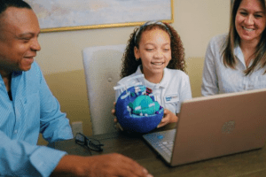 daughter in virtual school as parents look on, GREAT HEARTS ONLINE DFW HOMESCHOOL OPTIONS