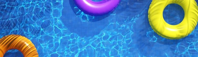 view from above of pool with several colorful inner tubes