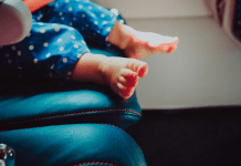 Little toddler toes on an airplane seat.