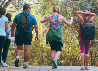 group of people walking on a trail from behind, benefits of walking more