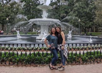 women posing in front of fountian, sistercation