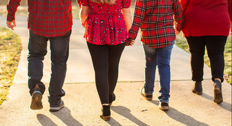 family walking on sidewalk from behind, benefits of walking more