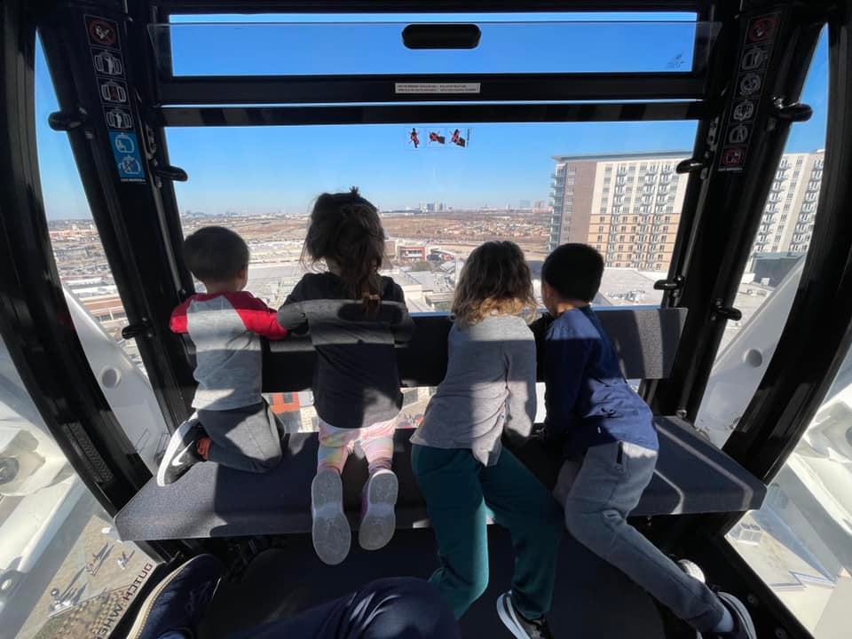 kids high in the grandscape ferris wheel, best areas in Collin County