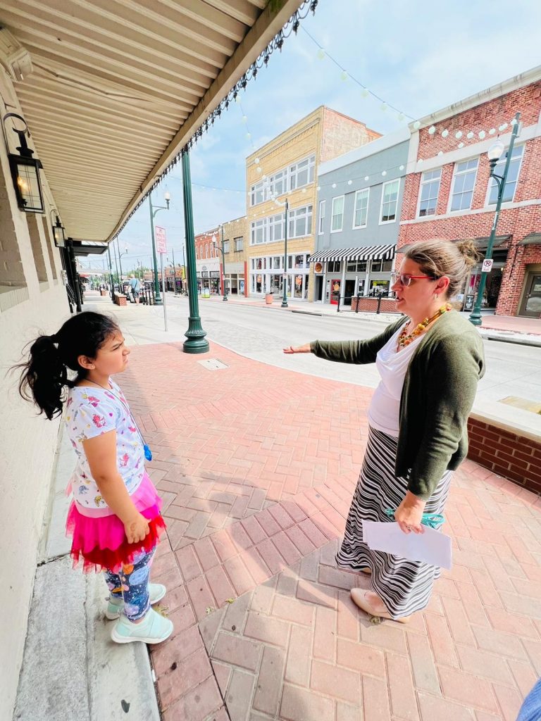 Downtown McKinney tour guide talking with little girl