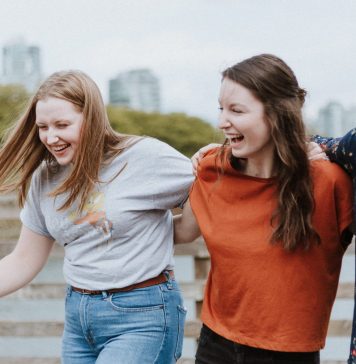 laughing women with linked arms, what is my attachment style