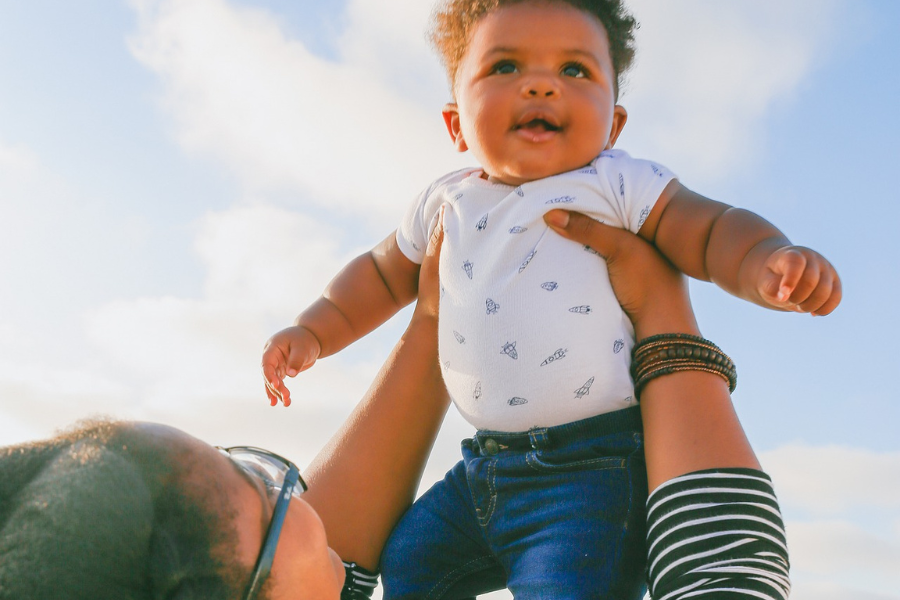 mother holds her baby up