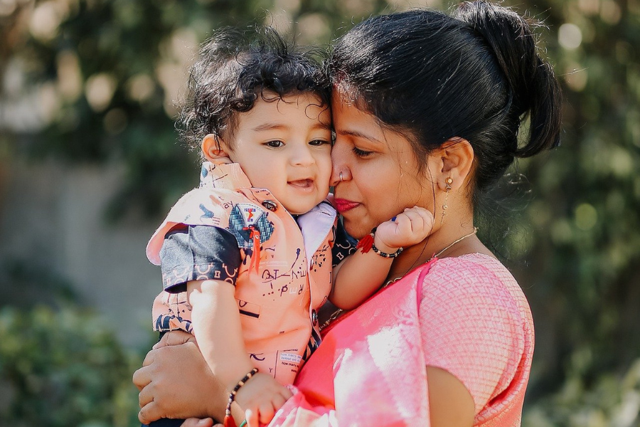 mother snuggles her baby boy's face