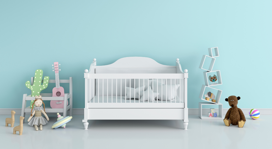 A crib in a blue room is a newborn essential.