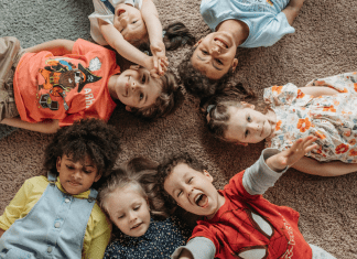 Kids laying on the ground.